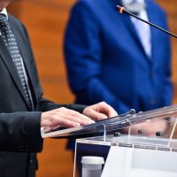 Detail shot with man in suits during a press conference