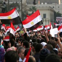 Men celebrating Mubarak’s step down in Tahrir sq.