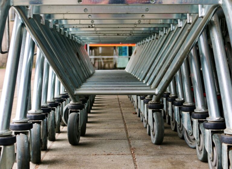 Rows of industrial carts with swivel casters viewed from below